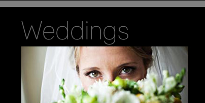 Woman In A Wedding Vail Looking Through A Bouquet Flowers
