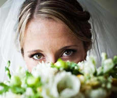Woman Bride Looking Through Flowers
